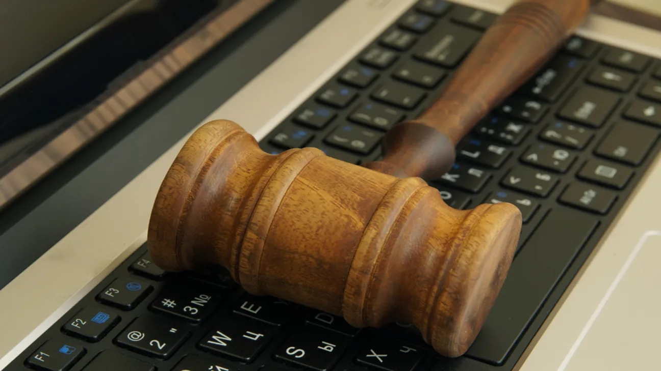 Gavel placed on top of laptop keyboard 