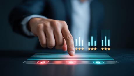 Business man's finger pointing down on a lighted computer chart.